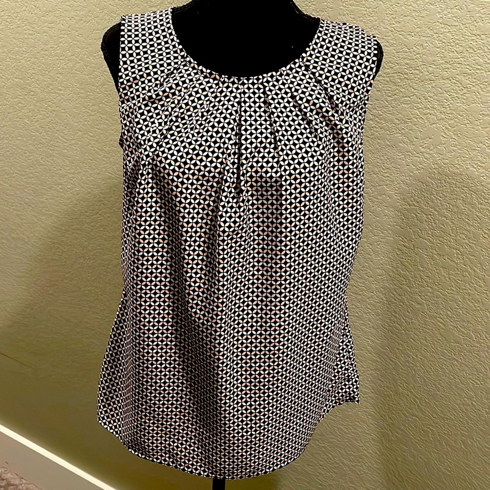 Sleeveless blouse and only worn a few times. Great condition